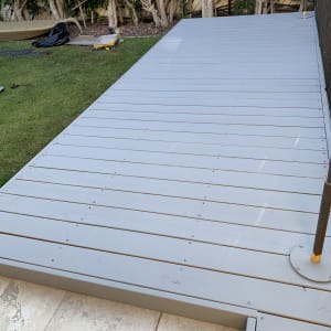 דק עץ בגינה עם עצים ברקע