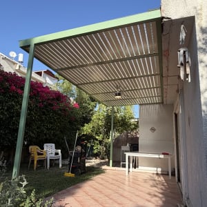 פרגולה אלומיניום בחצר עם ריהוט גן