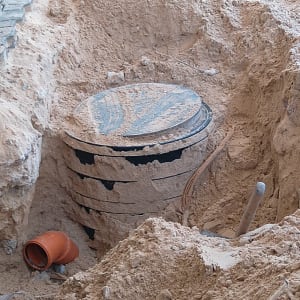 בור חפירה עם מכסה עגול וצינור כתום