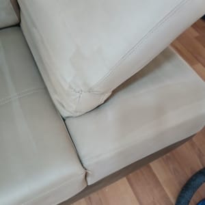 ספה עם כריות ותפרים, צינור כחול על הרצפה