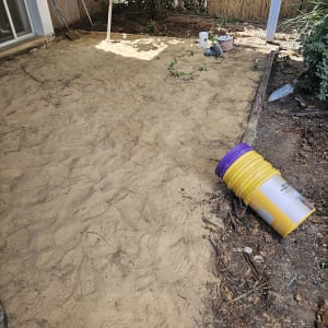 חול, דליים וכלים באתר שיפוץ חצר