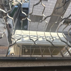 מזגן מותקן מחוץ לחלון עם סורגים