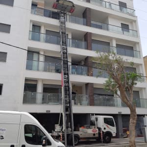 מנוף משאית מרים חפצים למרפסת בניין