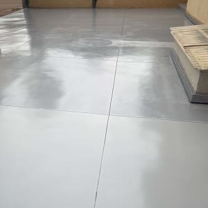 רצפת בטון חלקה בחצר עם גדר עץ