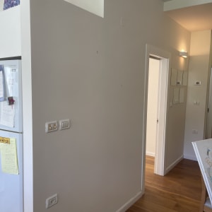 קיר לבן עם מתגי חשמל וציור על שולחן