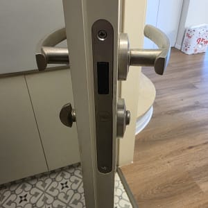 ידית ודלת עם מנעול ייל על רצפת אריחים מעוצבת