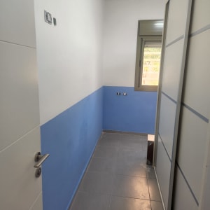 קיר צבוע חצי כחול חצי לבן בחדר קטן