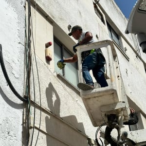 אדם בעבודה על בניין עם מנוף