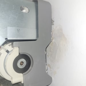 חלק ממזגן עם כיסוי פלסטיק אפור על קיר לבן