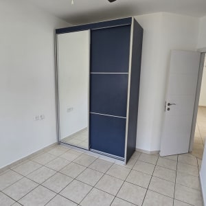 חדר ריק עם מאוורר תקרה וארון בגדים