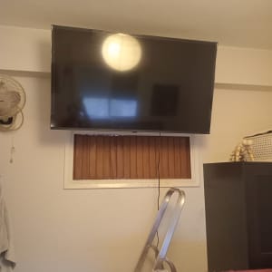 טלוויזיה מותקנת על הקיר עם סולם וכלים