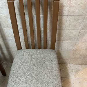 כיסא עם מושב מרופד על רקע קיר אריחים