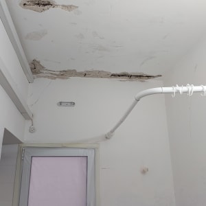 תקרה מתקלפת עם סימני רטיבות ושקעים