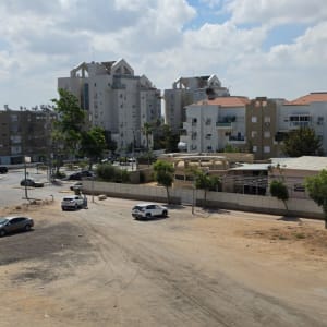 נוף עירוני עם בניינים ומגרש חניה ריק