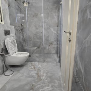 חדר אמבטיה משופץ עם מקלחון ושירותים מודרניים