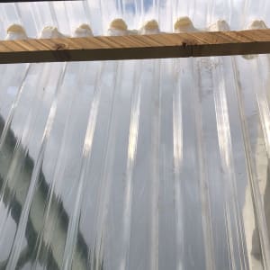 גג פלסטיק שקוף עם קורות עץ ותמיכה