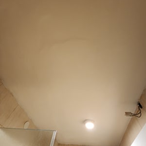 תקרה צבועה בצבע בהיר עם מנורה עגולה