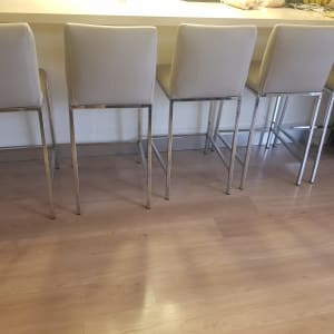 חמישה כיסאות בר מרופדים בצבע בהיר