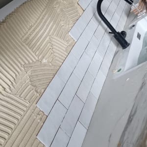 התקנת אריחים במטבח עם כיור וברז שחור