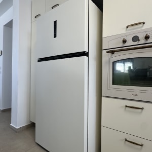 מקרר לבן עם דלתות חלקות במטבח מודרני