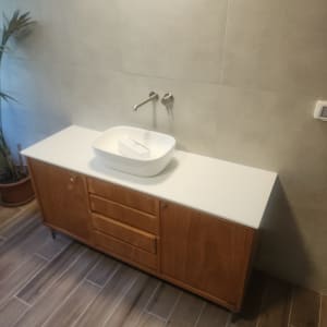 כיור על משטח עץ עם ברז קיר