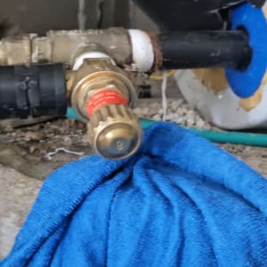 שסתום לחץ וחיבורי צנרת אינסטלציה במהלך תיקון נזילה