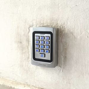 לוח מקשים עם תאורה כחולה על קיר לבן