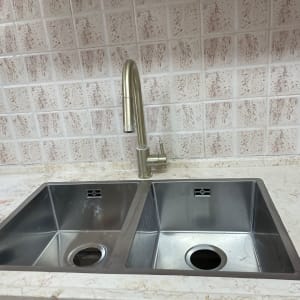 שיש בהיר עם כיור כפול וברז מתכת