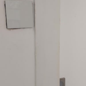 מתג חשמלי על קיר לבן ליד דלת