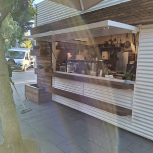 דוכן עץ עם מדפים וכלי מטבח, ללא אנשים נראים