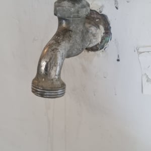 ברז מתכת ישן עם נזילה קלה