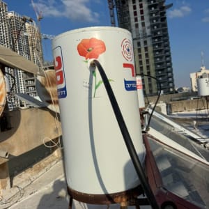 דוד שמש על גג עם רקע של בניינים גבוהים