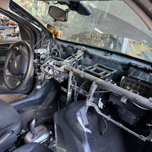 פנים רכב מפורק עם חוטי חשמל חשופים ולוח מחוונים חסר