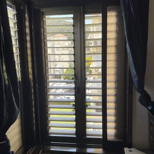 חלון אלומיניום עם תריסים פתוחים למחצה