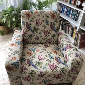 כורסה עם ריפוד פרחוני וציפורים צבעוניות