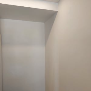 קיר גבס לבן עם תאורה עליונה