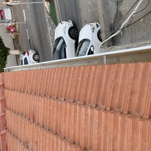 גג רעפים אדומים עם כבלים חשמליים בצד