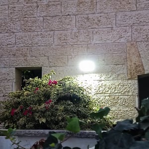 Outdoor wall light illuminating a stone wall