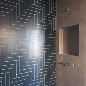 קיר אריחים כחולים בעיצוב זיגזג, שקע בקיר