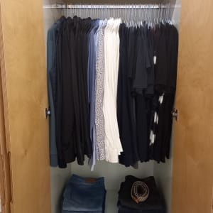 ארון בגדים מסודר עם חולצות ומכנסיים מקופלים