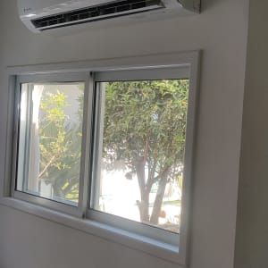 מזגן מותקן על קיר מעל חלון