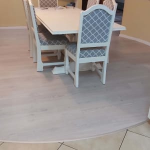 רצפת פרקט בהירה בחדר אוכל עם שולחן וכיסאות