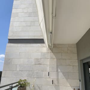 סוכך מותקן על קיר מרפסת עם חוט תלוי