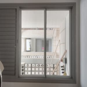 חלון אלומיניום עם תריסים אפורים