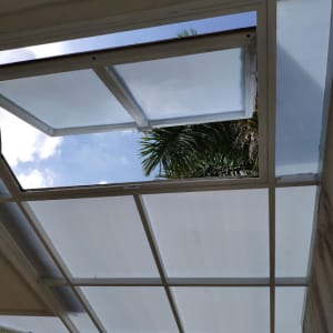 סוכך זכוכית פתוח עם מסגרת מתכת לבנה