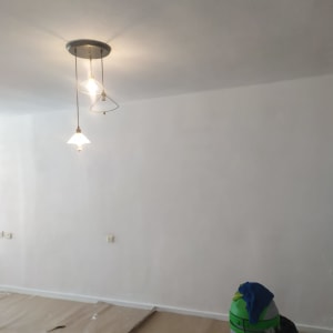 שואב אבק ירוק ומטלית כחולה על הרצפה