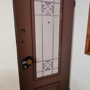 דלת חומה עם עיטורים מתכתיים וזכוכית