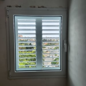 חלון אלומיניום עם תריסים פתוחים