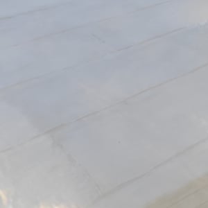 גג שטוח עם ציפוי לבן ומזגן חיצוני