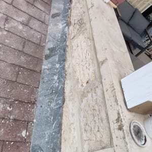 ערימת אריחים על רצפת אבן ליד קיר בטון